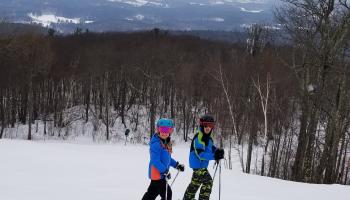 Two people on a ski mountain
