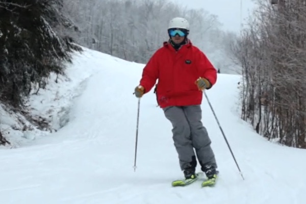 Skiers going down ski slope