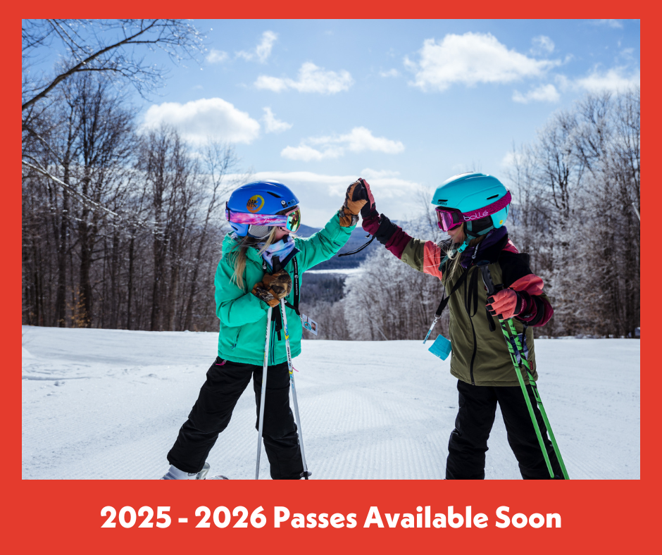 Kids doing a high five on the slopes