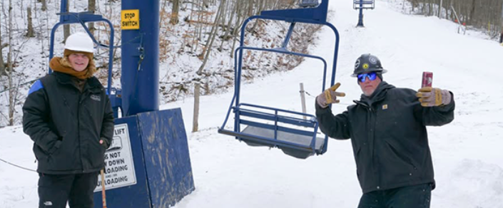 Employees near a chair