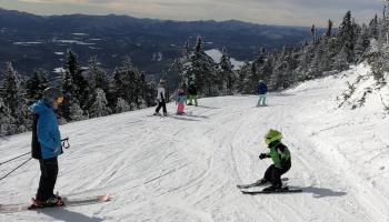 little boy skiing with dad 