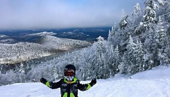 A skier standing on mountain slope