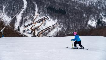 A skier going down a ski slope