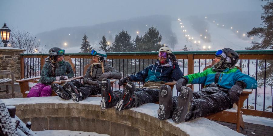 Skiers relaxing by fire place